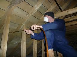 A pest controller treating for woodworm with pesticides.